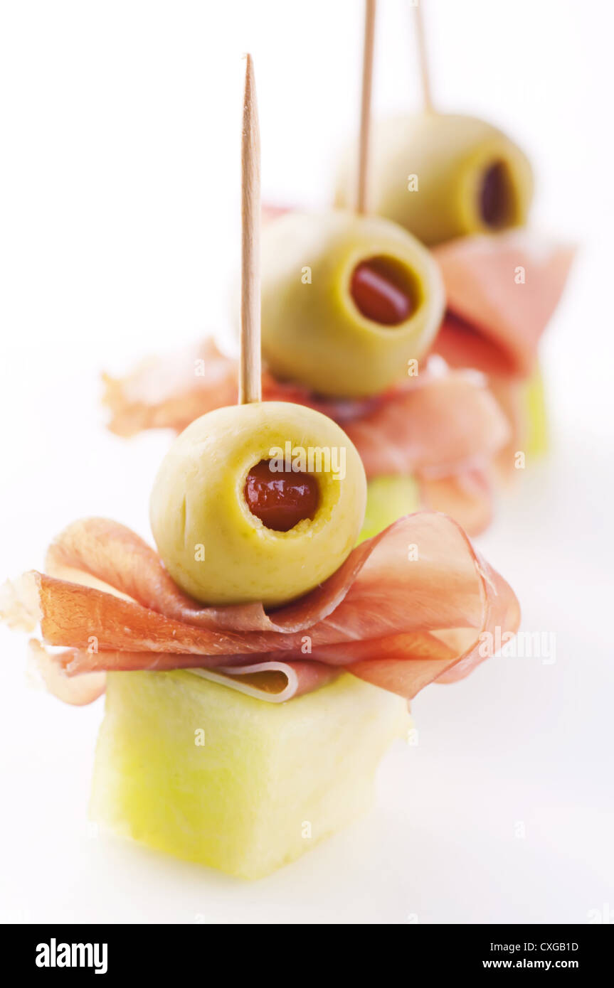 canapes with ham and pickled olives Stock Photo