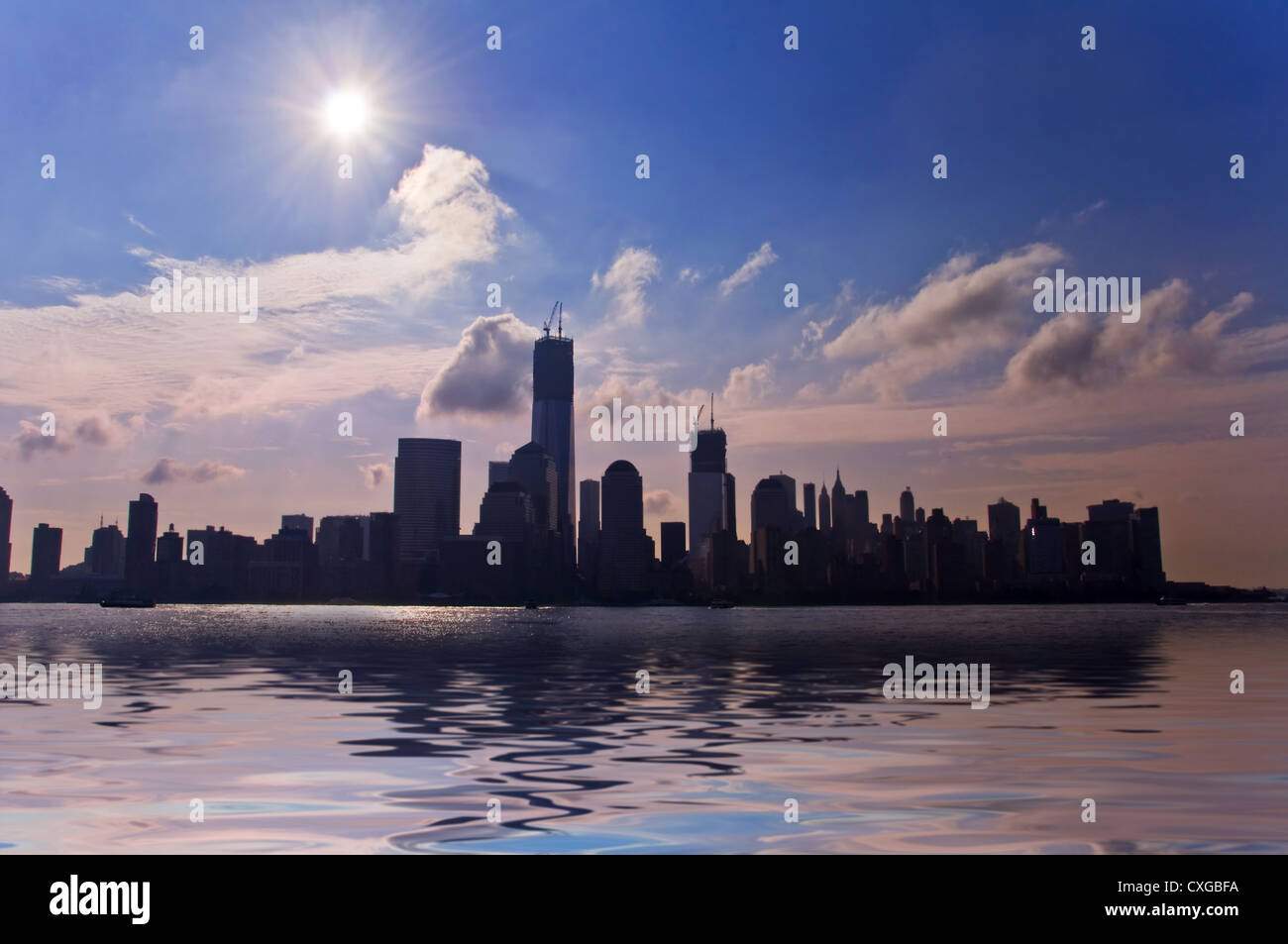 Silhouette of downton Manhattan skyline against light, freedom tower in construction view from Jersey-City - New York USA Stock Photo