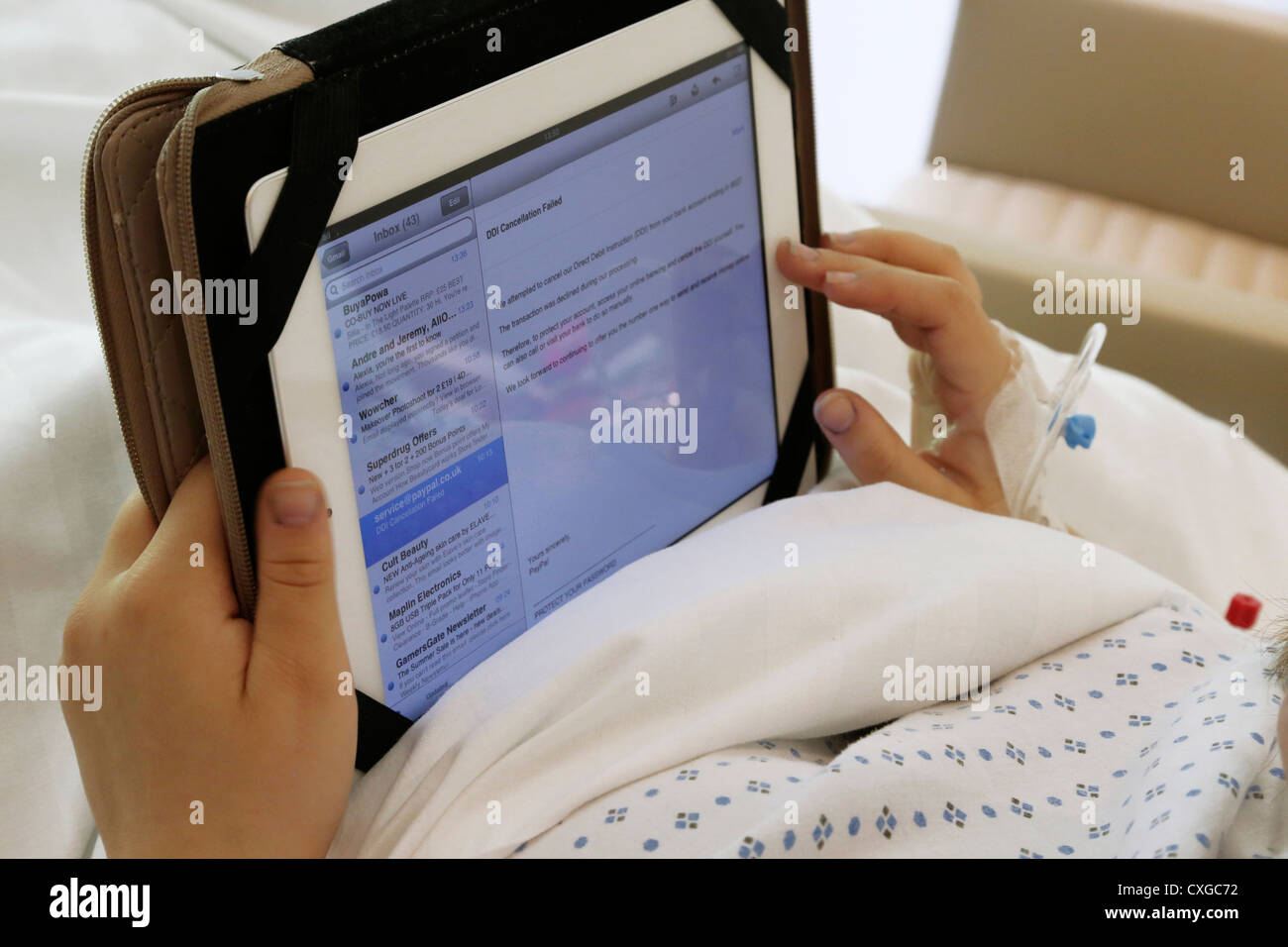 Patient With Cannula In Hospital Bed Working On iPad Ashtead Surrey