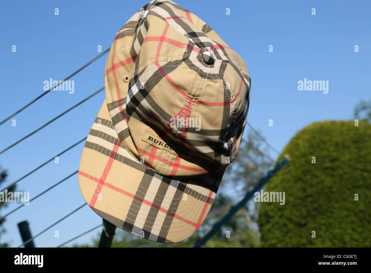 Burberry Golf Cap Hanging on Washing Line Stock Photo