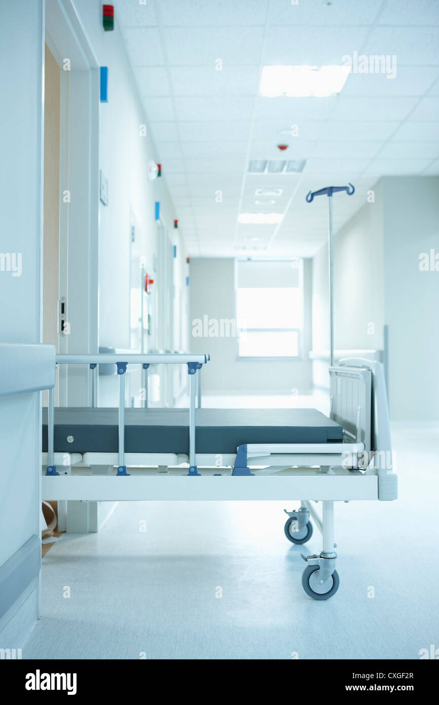 A empty hospital bed half way out of a room Stock Photo Alamy
