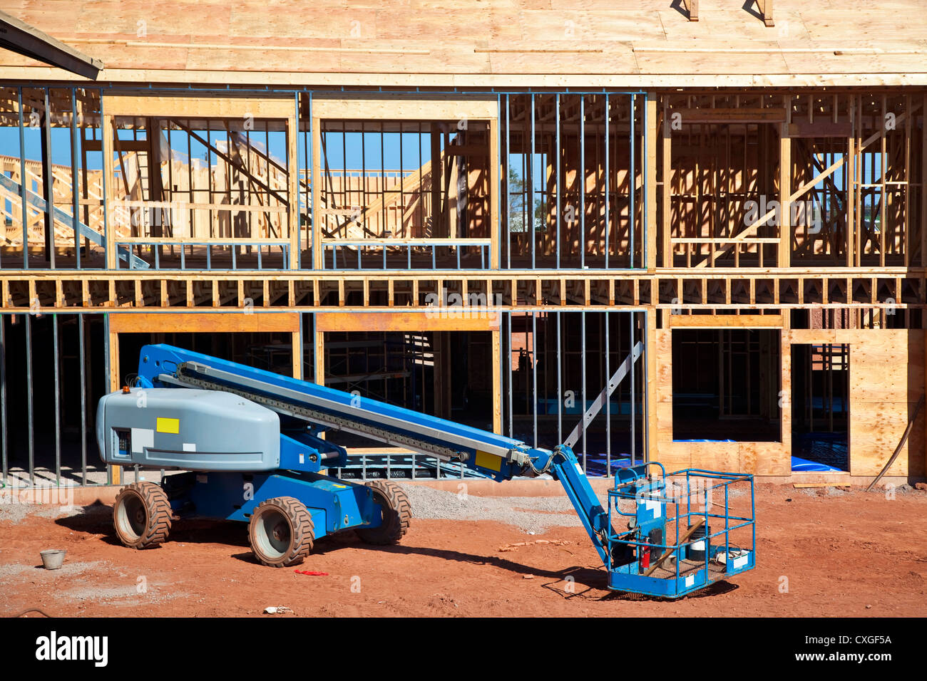 A boom lift with a telescopic arm on a construction site. Stock Photo