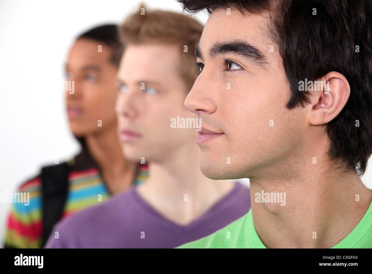 Young people with their eyes fixed on an object Stock Photo