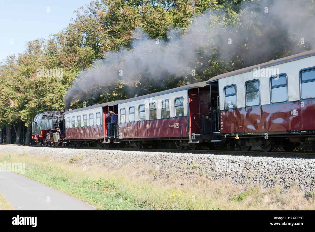 Steam locomotive pulling a passenger train. The Molli bahn at Bad Doberan - Germany Stock Photo