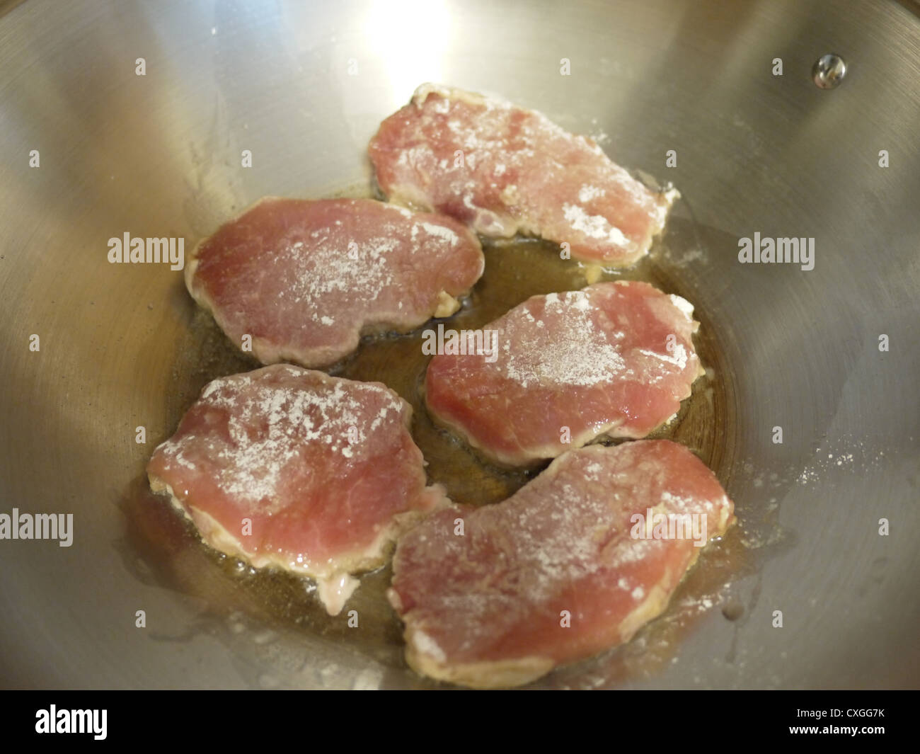 cooking frying pork chops oil wok Stock Photo Alamy
