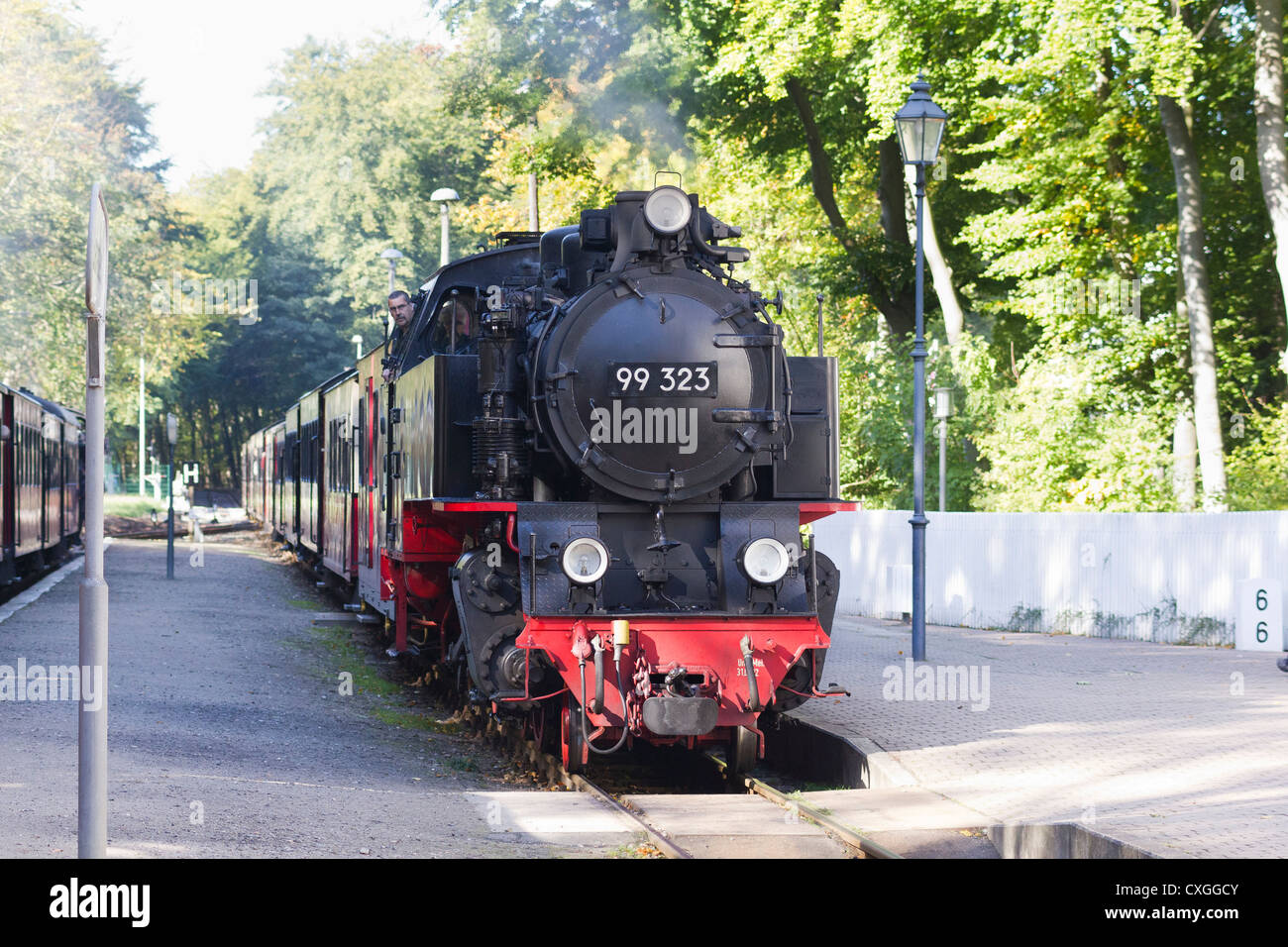 Steam locomotive pulling a  passenger train. The Molli bahn arriving at Heiligendamm - Germany Stock Photo