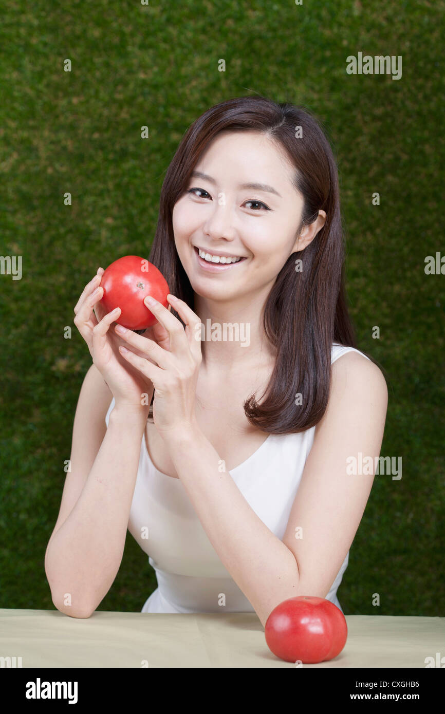 woman holding tomatoes on her hands Stock Photo - Alamy