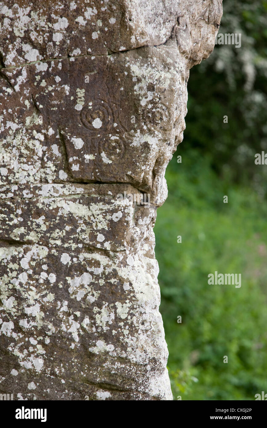 Cup and ring carvings in a cliff face overhanging the River Coquet at Morwick in Northumberland Stock Photo