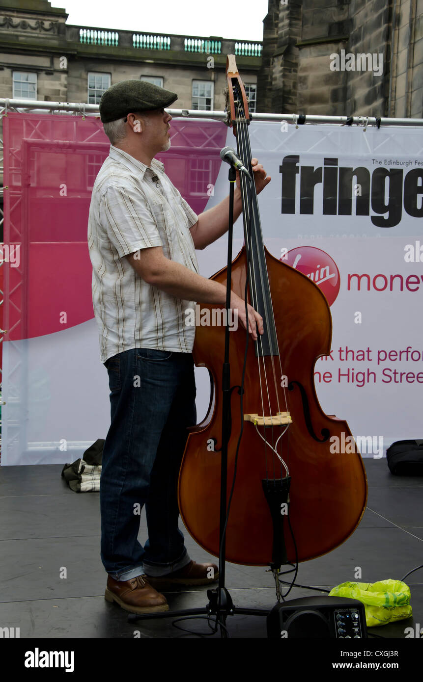 Double bass player with The Public House Orchestra busking in the Royal