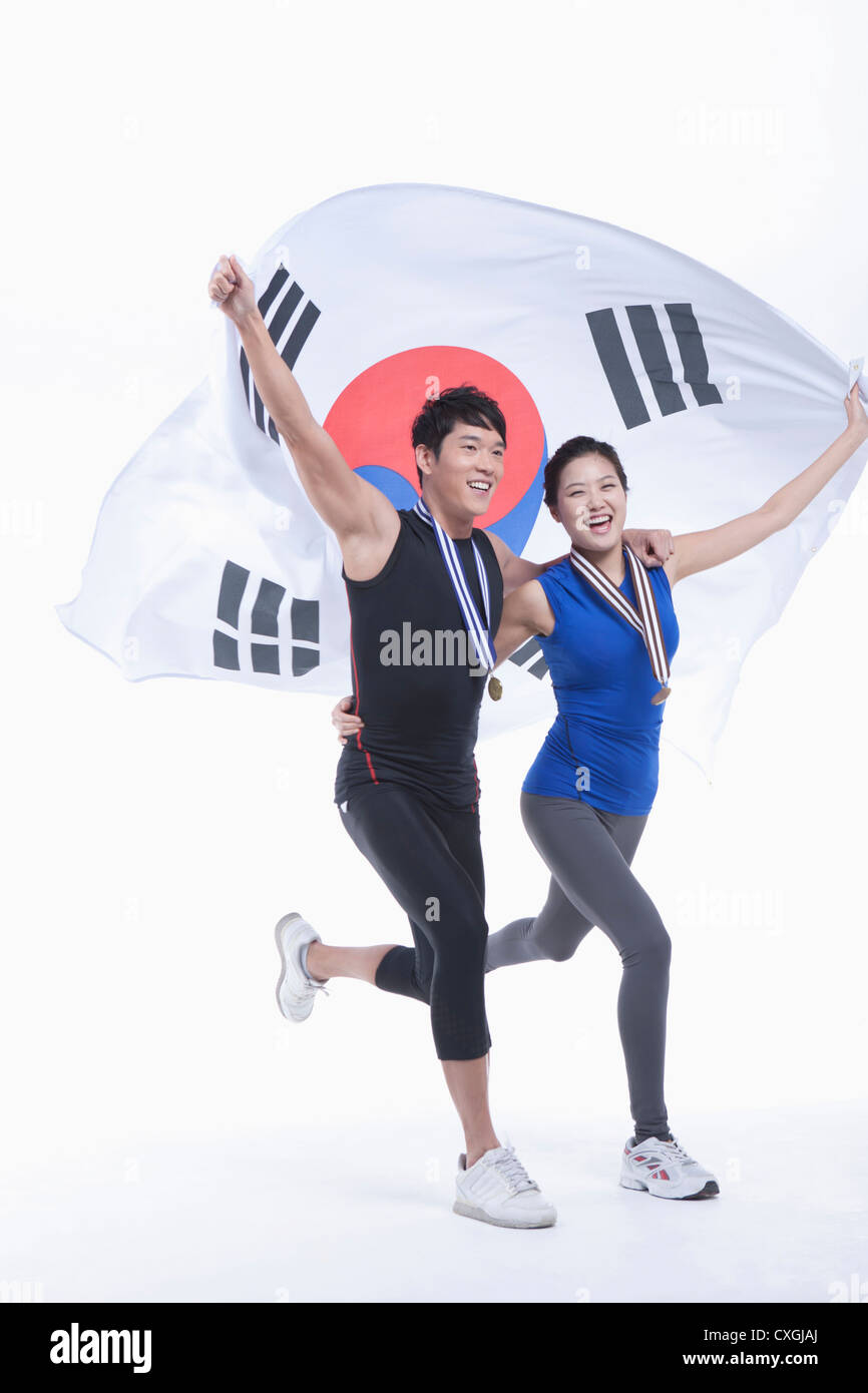 a couple holding Korean national flag on his hands and wearing a medals Stock Photo