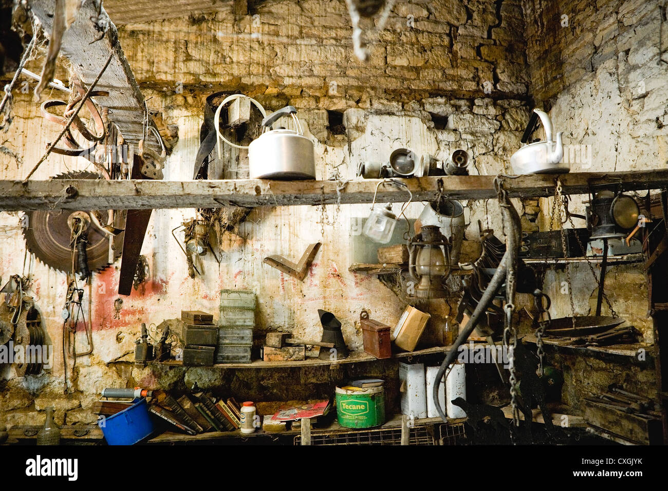 Old stone Garden Shed with assortment of tools and bric-a-brac Stock Photo