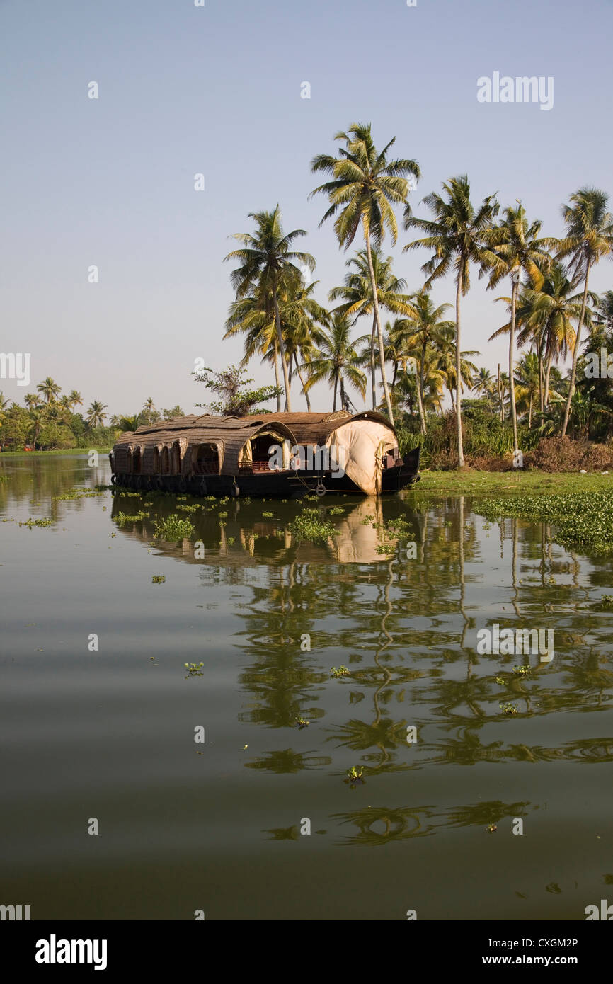 Traditional house boat sailling along the canal in the backwaters near Alleppey, Kerala, India. Stock Photo