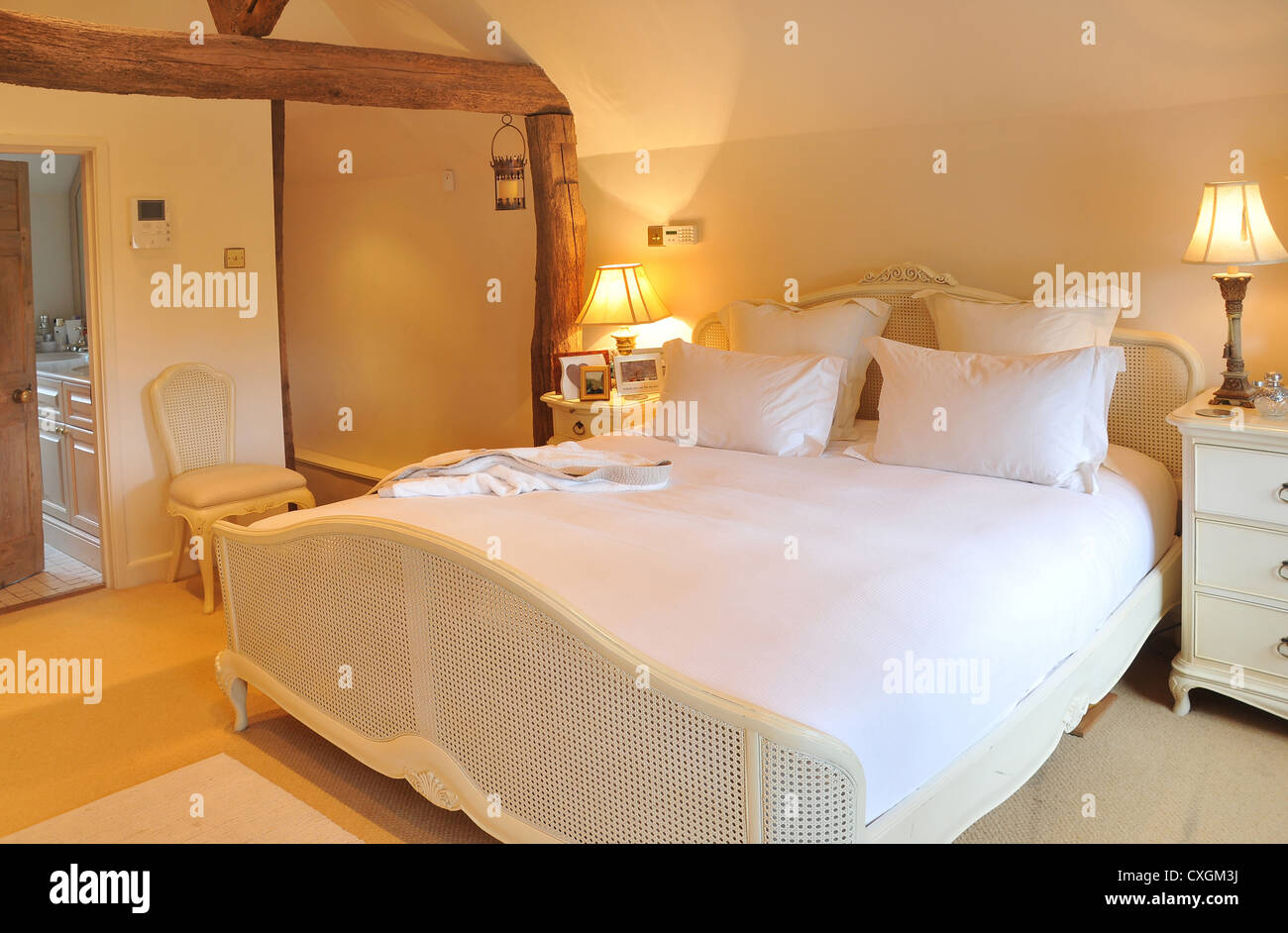 The Interior Designed Bedroom Of An English Cottage With Bed