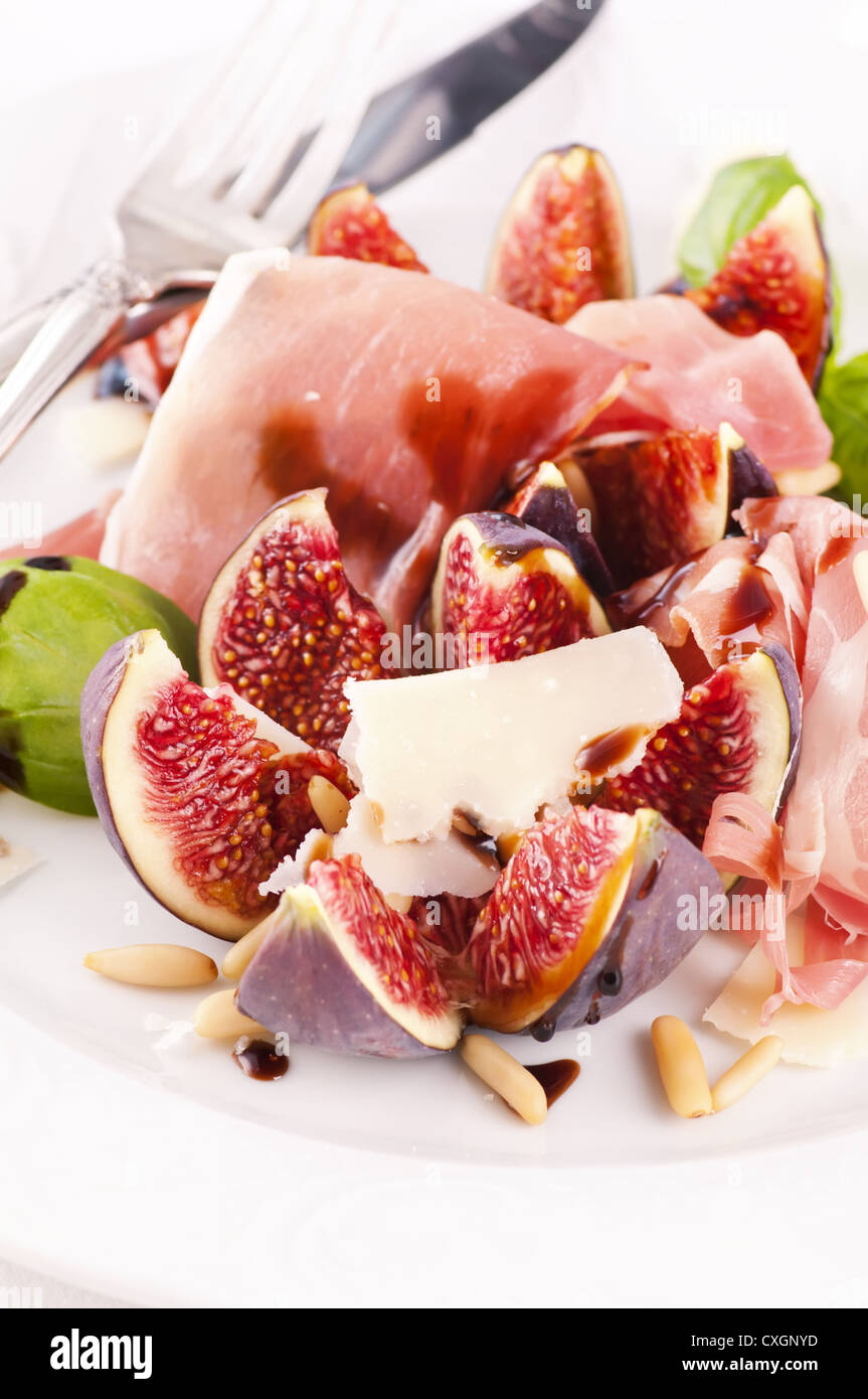 Fig with prosciutto and parmesan as starter Stock Photo