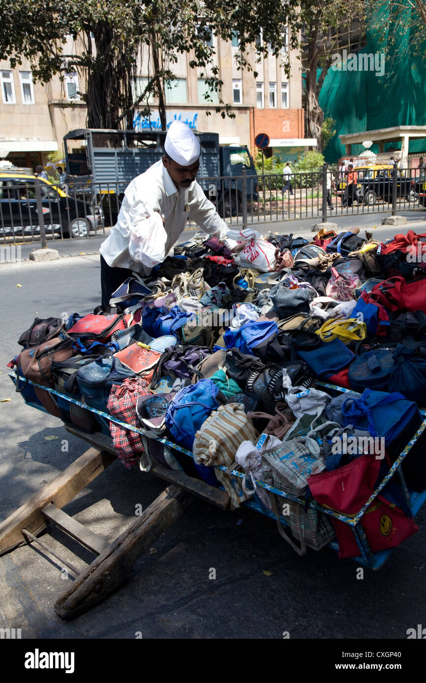 Dabbawala Tiffen box delivery man organising his clients lunch boxes, Mumbai, India. Stock Photo