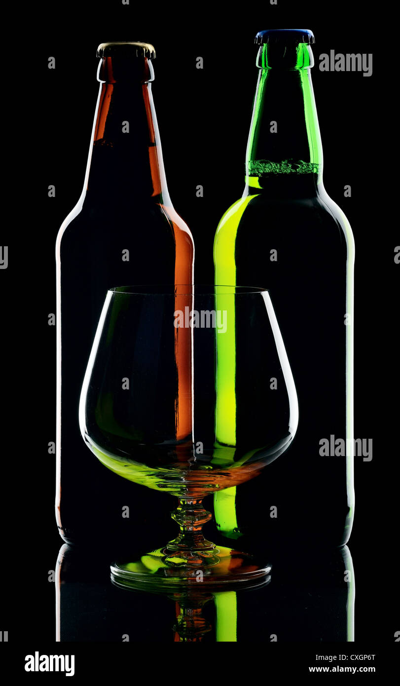 Two bottles of beer and glass, isolated on a black background Stock