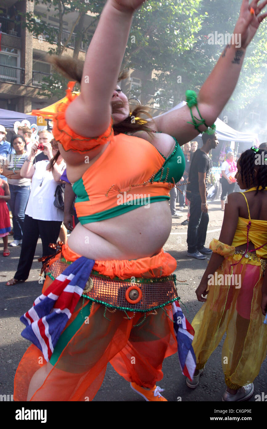 Overweight woman dancing at Notting Hill Carnival London Stock Photo