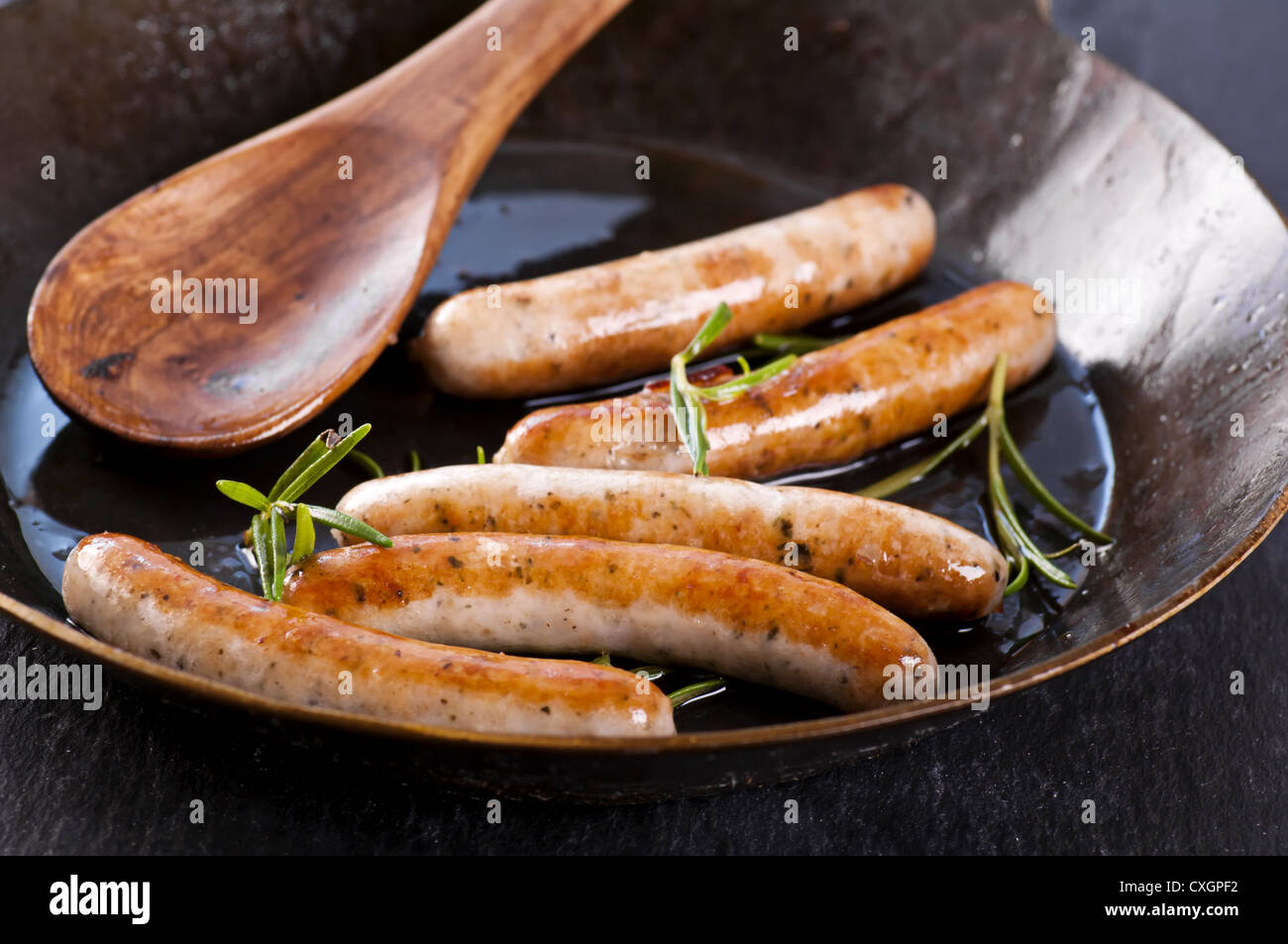 bratwurst roasted in the frypan Stock Photo Alamy