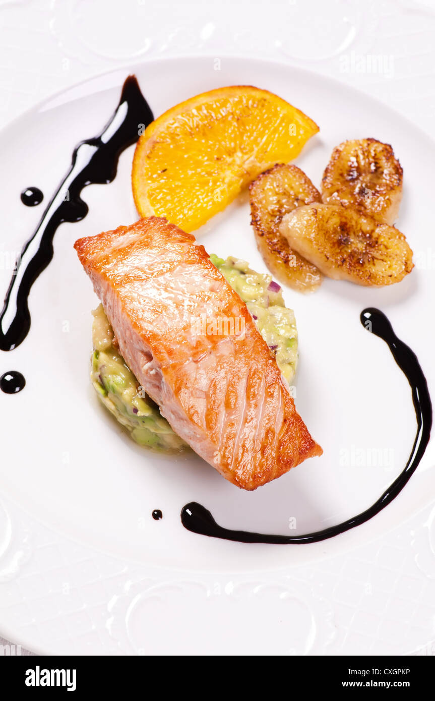 Salmon steak with avocado cream and calamelised fruits Stock Photo Alamy