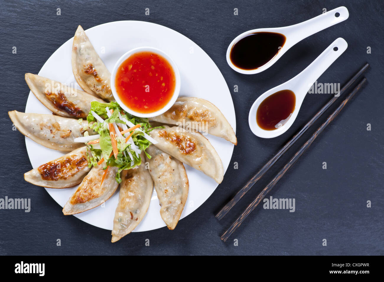 Fried Jiaozi with dipping sauces Stock Photo Alamy
