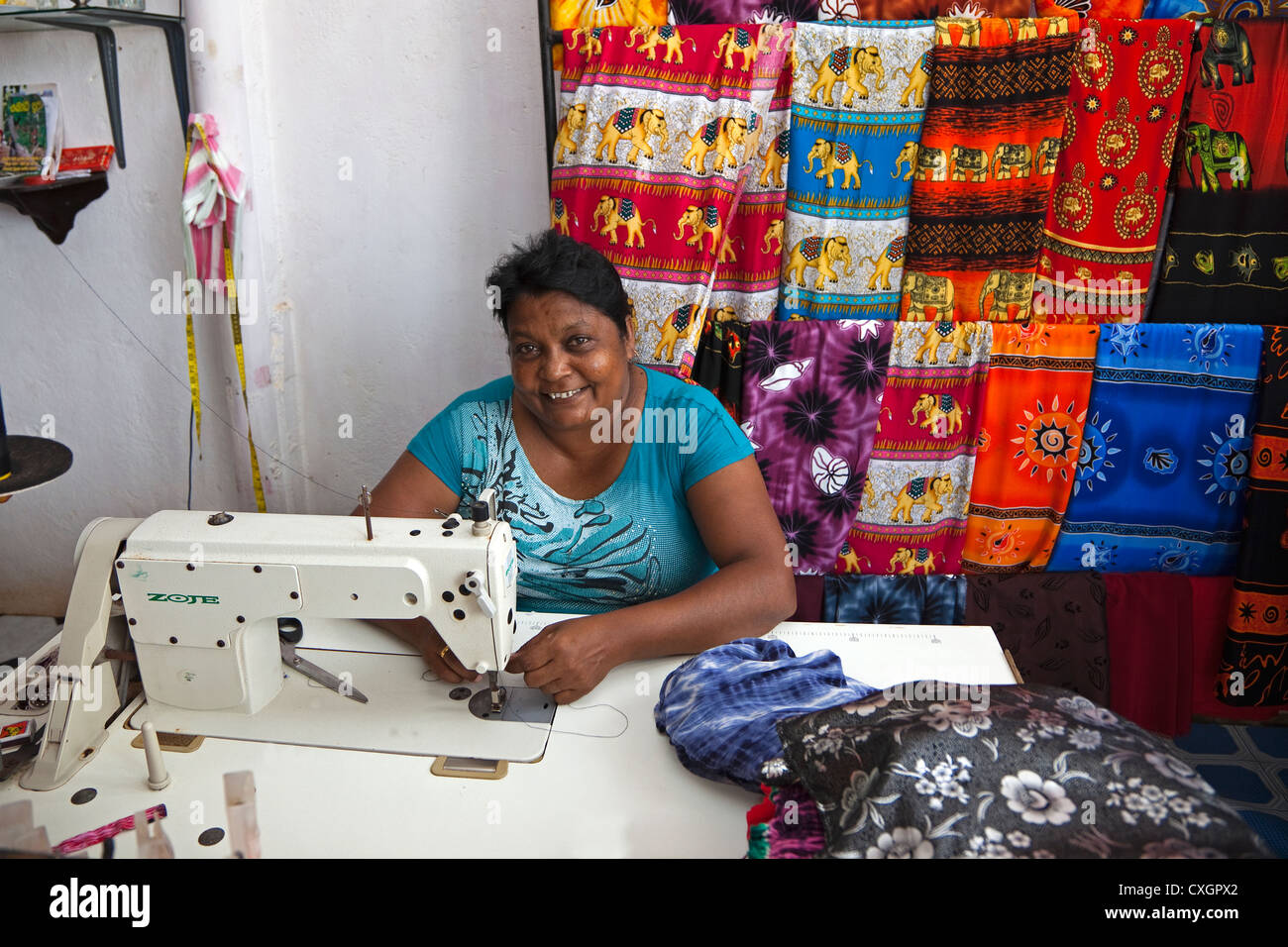 Woman from Waikkal village, Sri Lanka working at a sewing machine