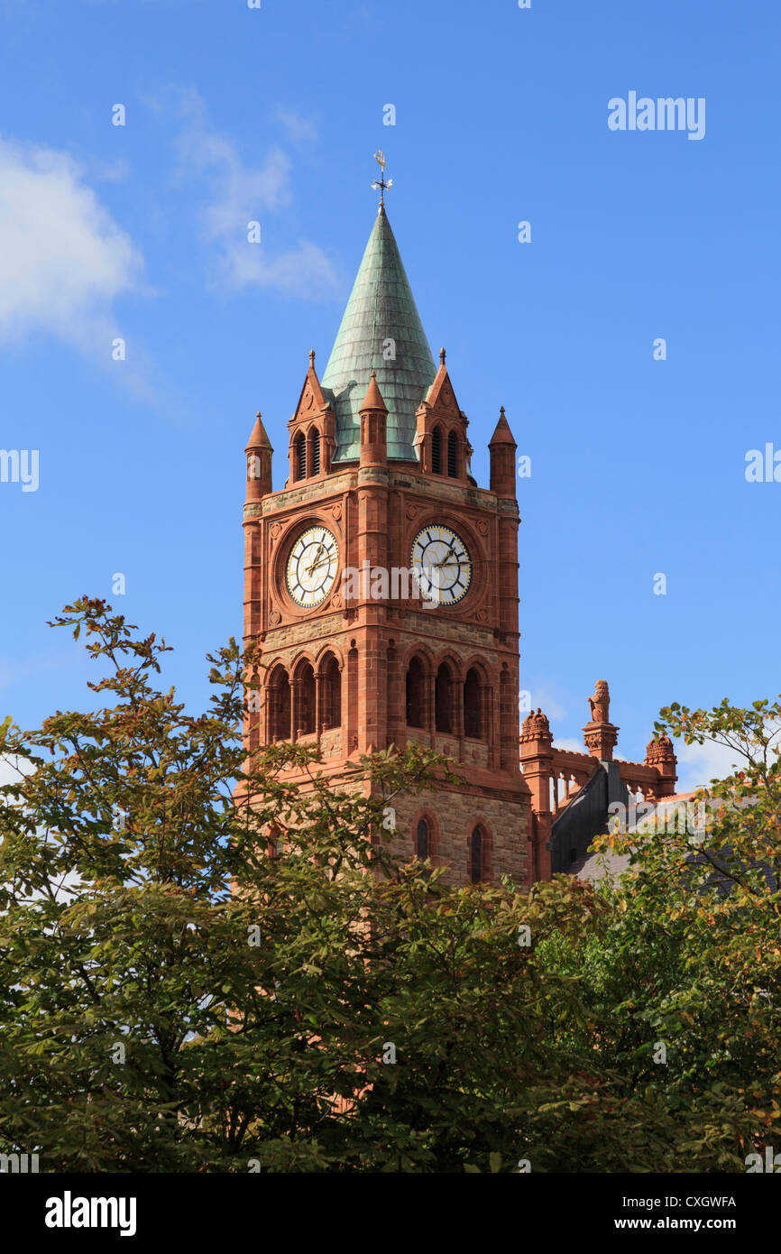 Guildhall clock tower towering above the trees in Derry city, Co ...