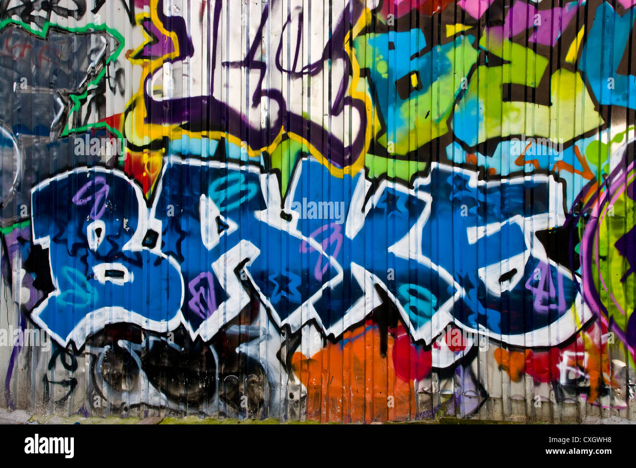 Vibrant urban graffiti street art with word bake on metal wall London England Europe Stock Photo