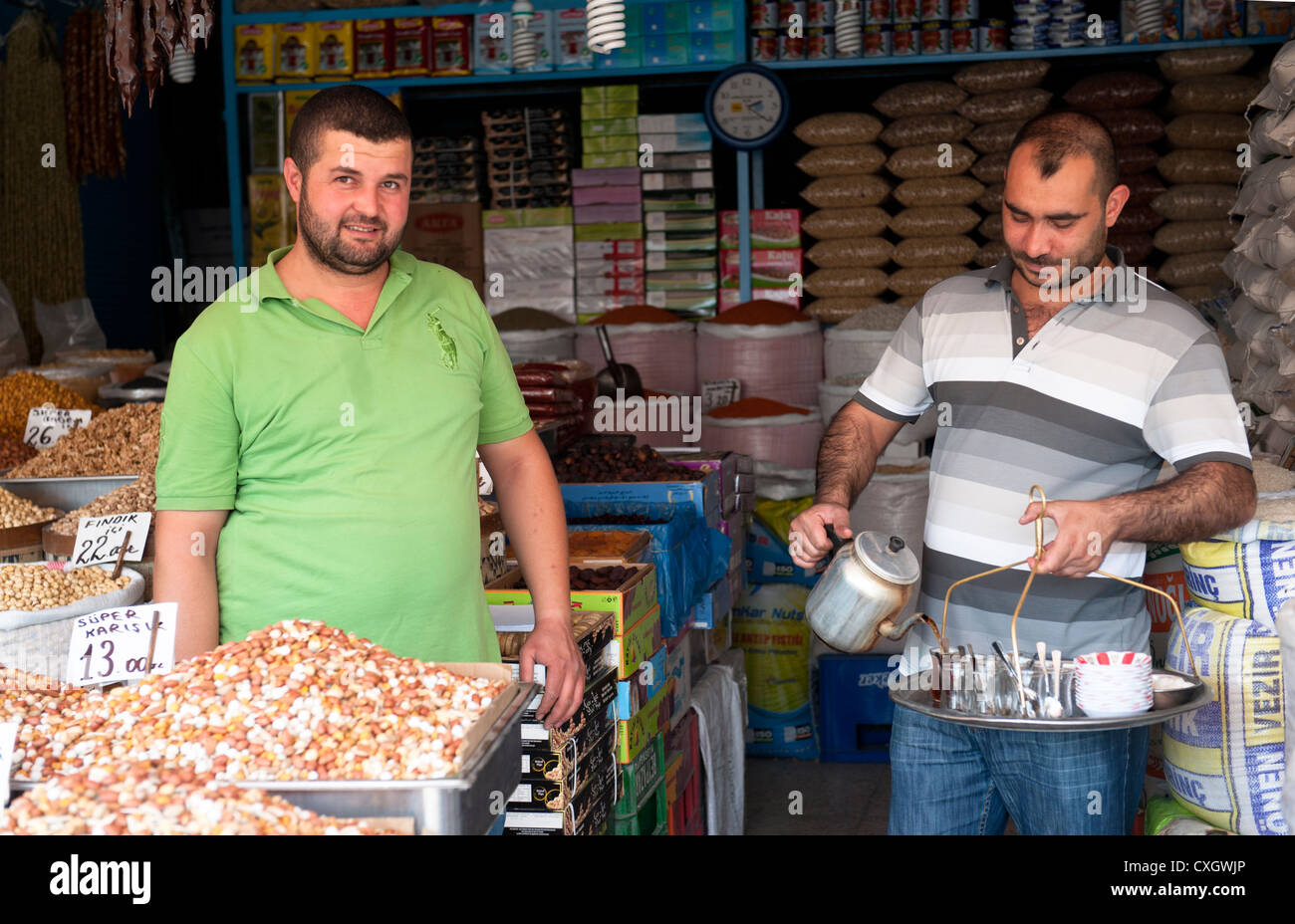 Tea valet serving a spice vendor in the old town of Ankara, capital of Turkey Stock Photo