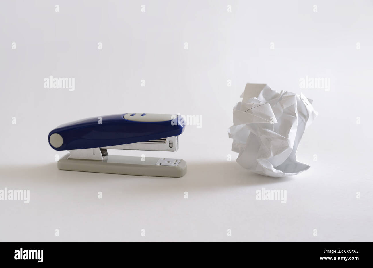 stapler and crumpled sheet of paper Stock Photo