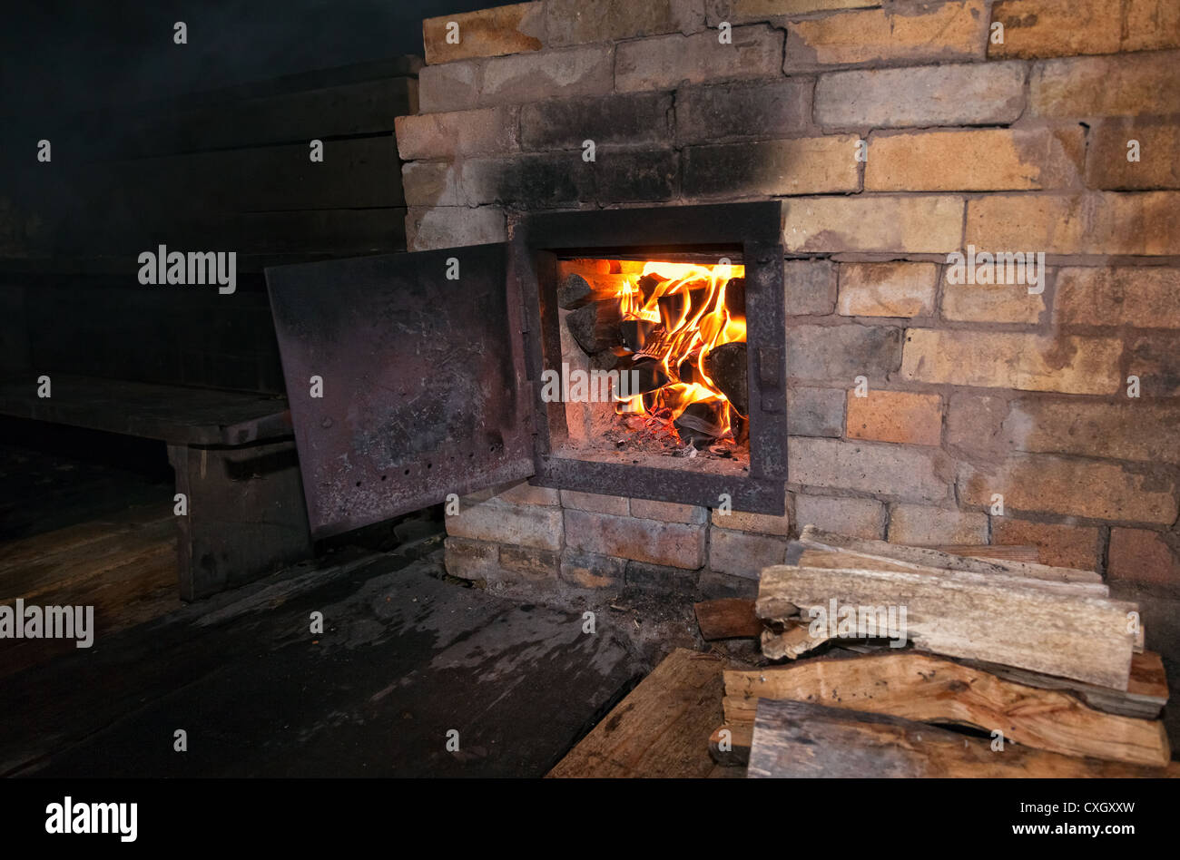 Old stove with open door and burning the wood Stock Photo