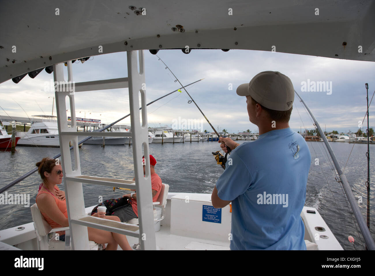 mate preparing tackle for tourists on a charter fishing boat out of key west florida usa Stock Photo