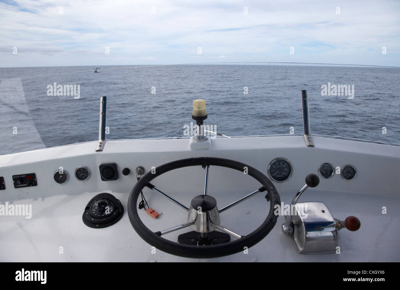 controls on the flybridge deck of a charter fishing boat in the