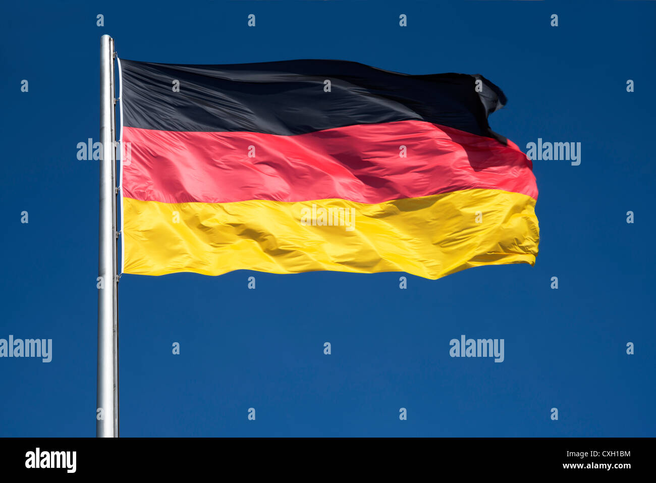 German flag against deep blue sky , colours black, red and gold, Germany, Europe Stock Photo