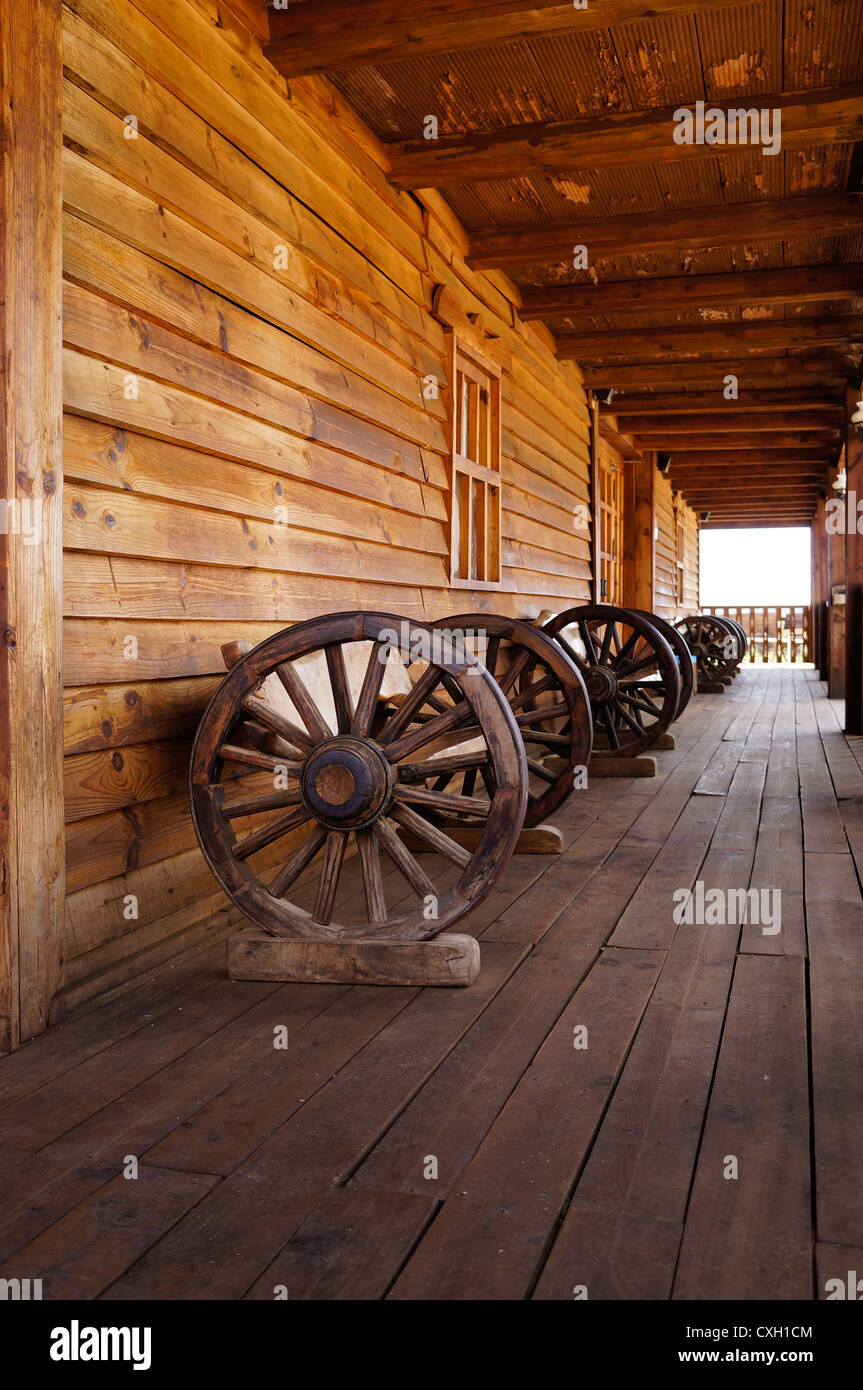 Inside of a old wild west saloon. A front view of Antique wagon wheel