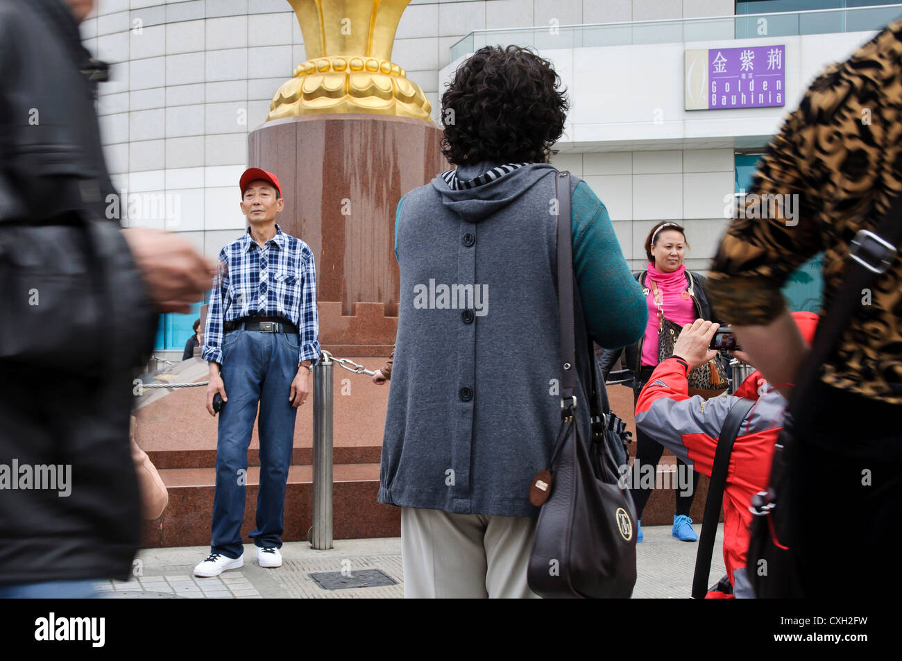 Mainland Chinese tourists pose for photos outside the Hong Kong Exhibition Centre, Wan Chai Stock Photo