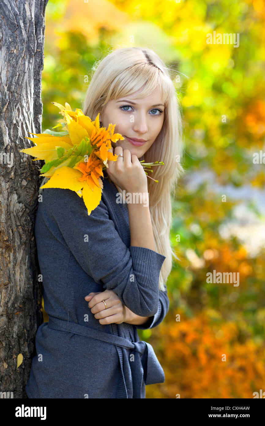 Young beautiful woman in autumn park Stock Photo - Alamy