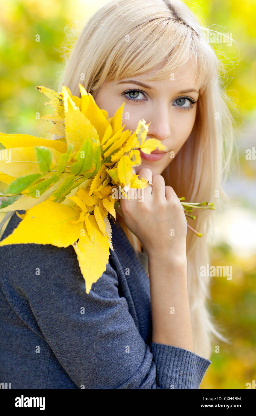 Young beautiful woman with a bouquet of autumn leaves Stock Photo - Alamy