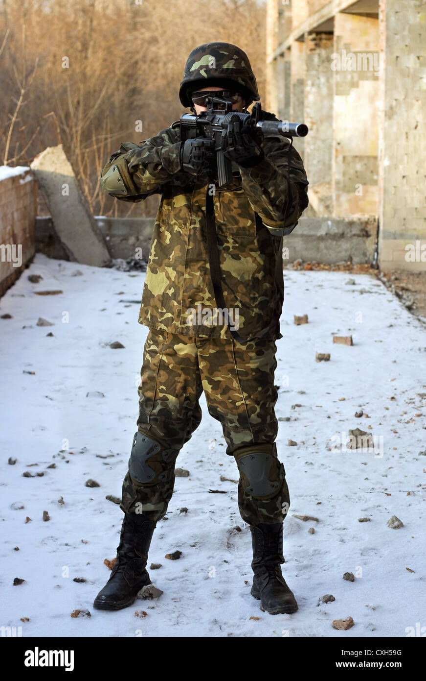 Soldier in camouflage with rifle Stock Photo