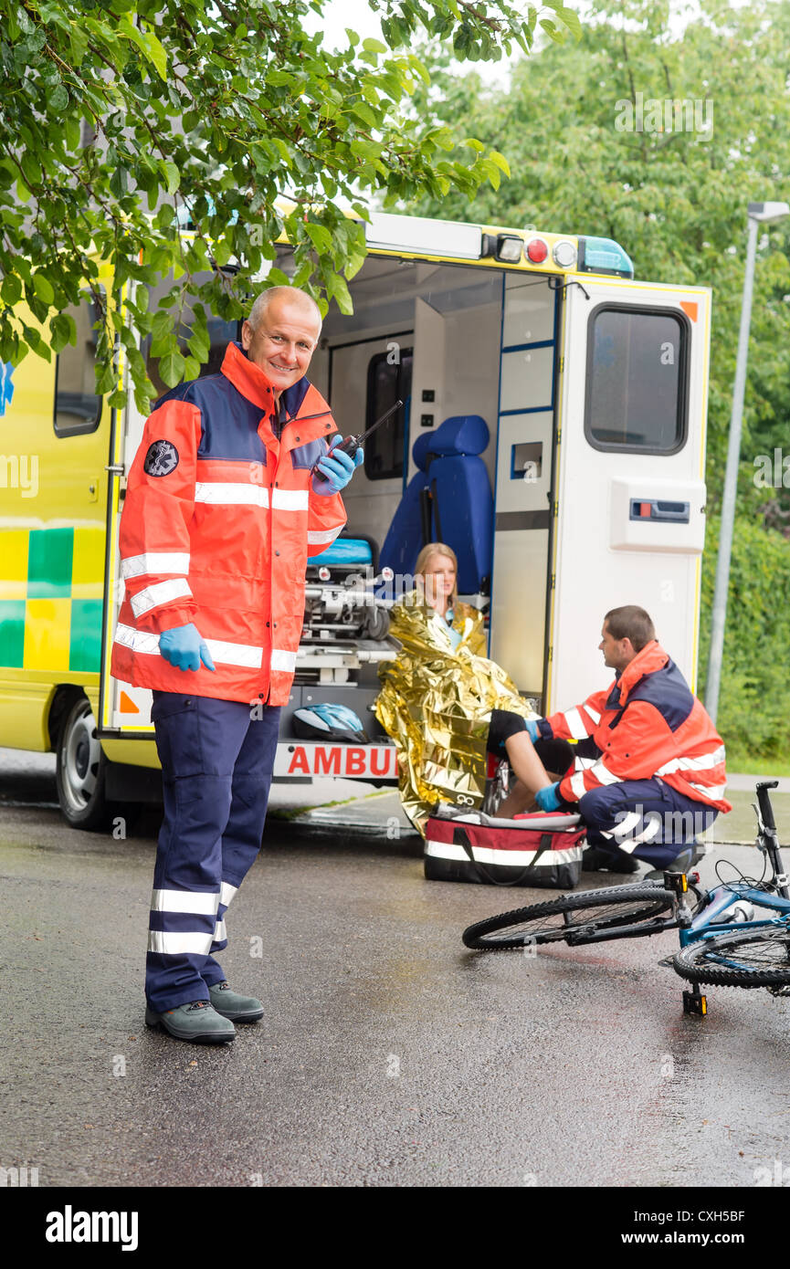 Emergency radio calling paramedics helping woman bike accident ...