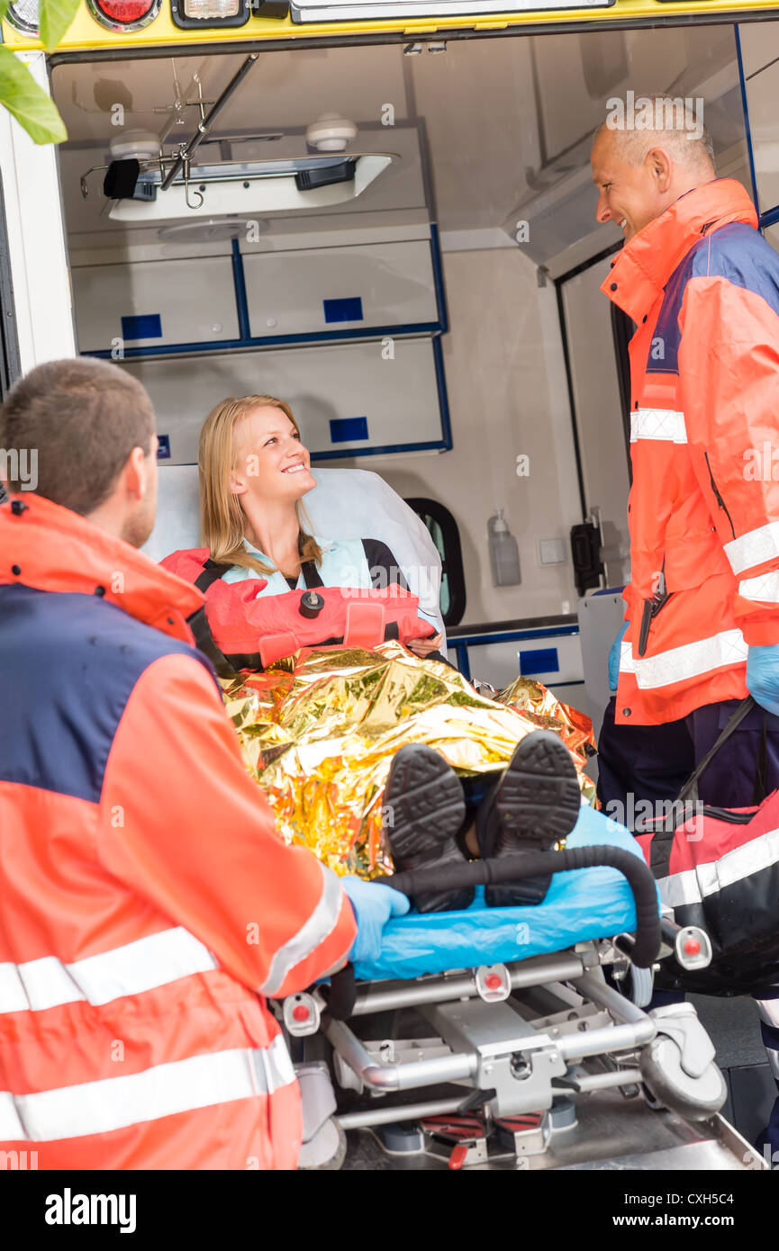 Emergency paramedics with injured woman in ambulance on stretcher Stock ...