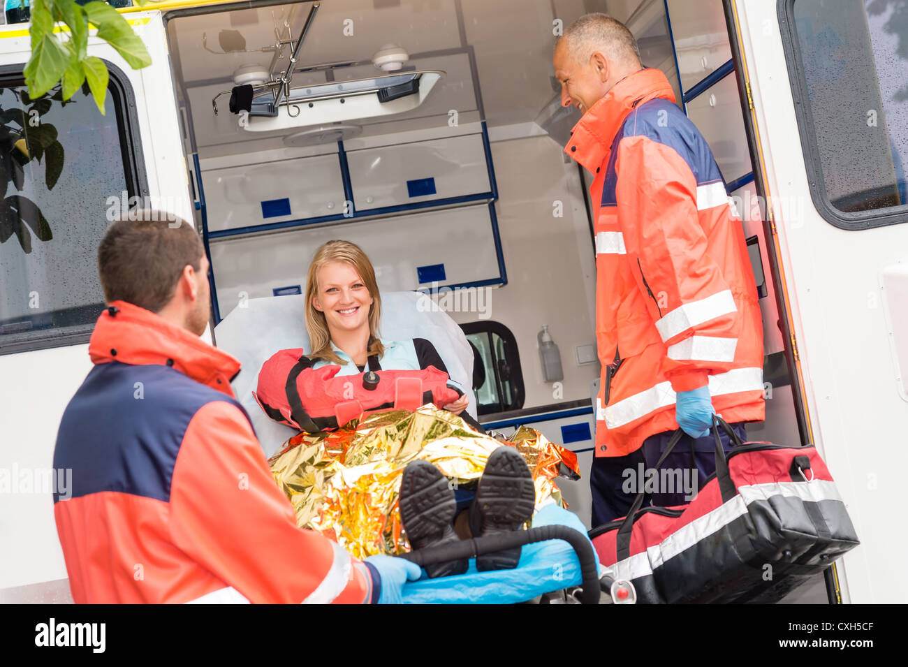 Emergency paramedics with injured woman in ambulance on stretcher Stock ...