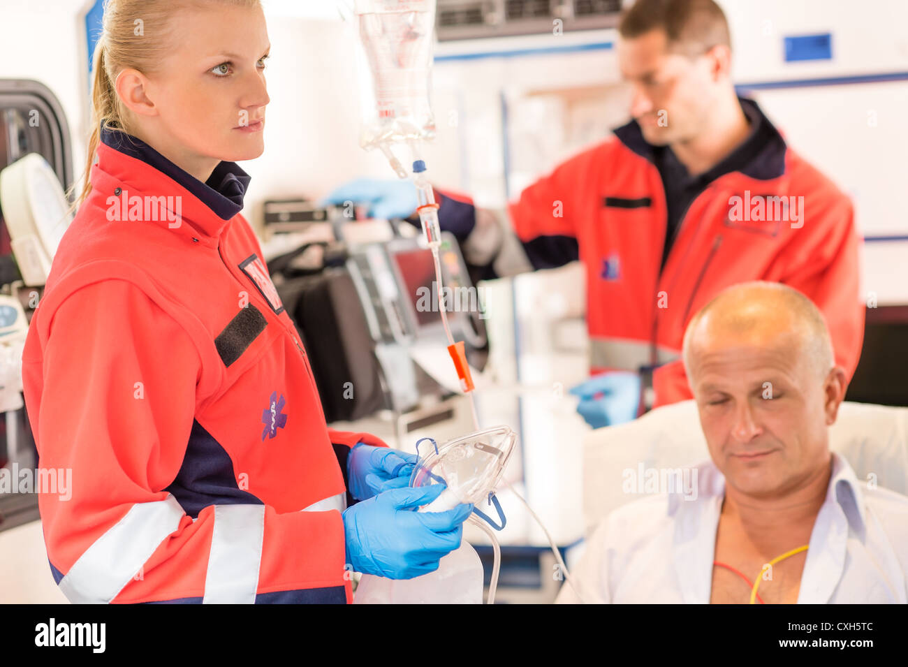 Paramedics in ambulance with patient heart attack treatment emergency