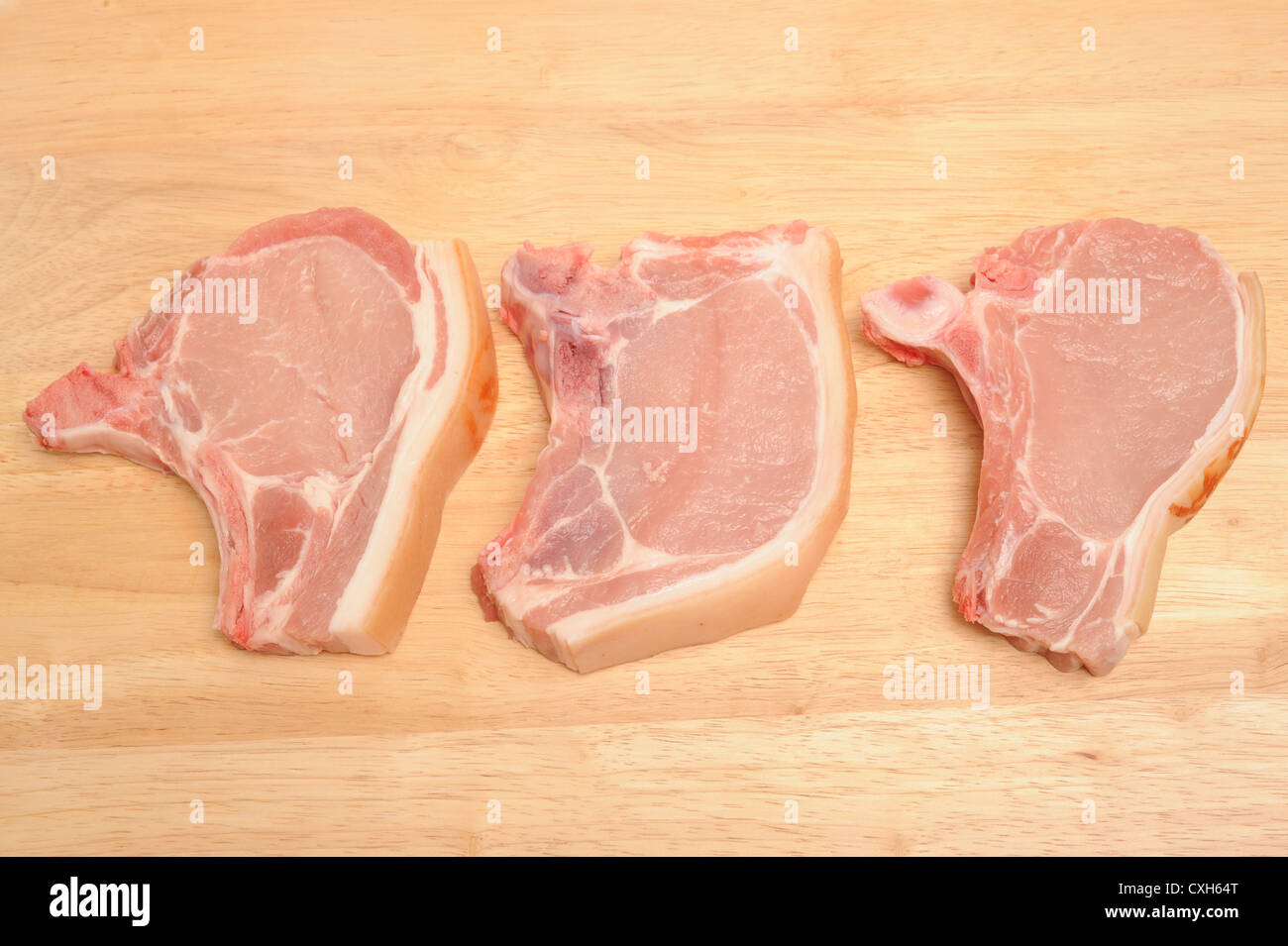 Pork chops on a work surface Stock Photo