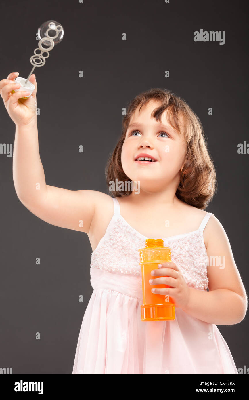 little girl blowing soap bubbles Stock Photo
