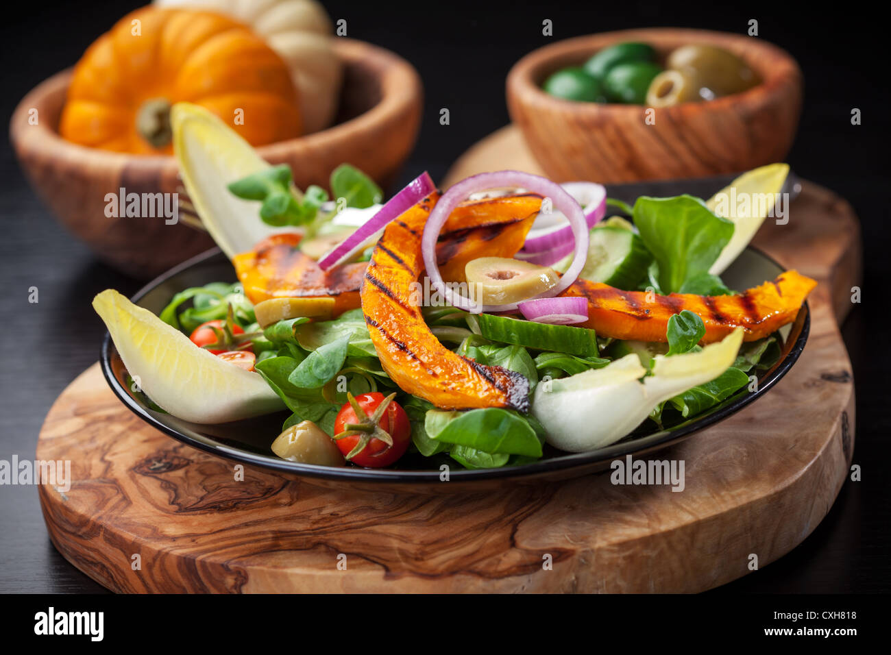 Delicious field salad with grilled pumpkin stripes for Thanksgiving Stock Photo