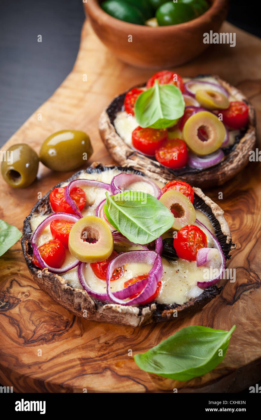 Giant Portobello mushrooms stuffed with mozzarella and tomatoes Stock