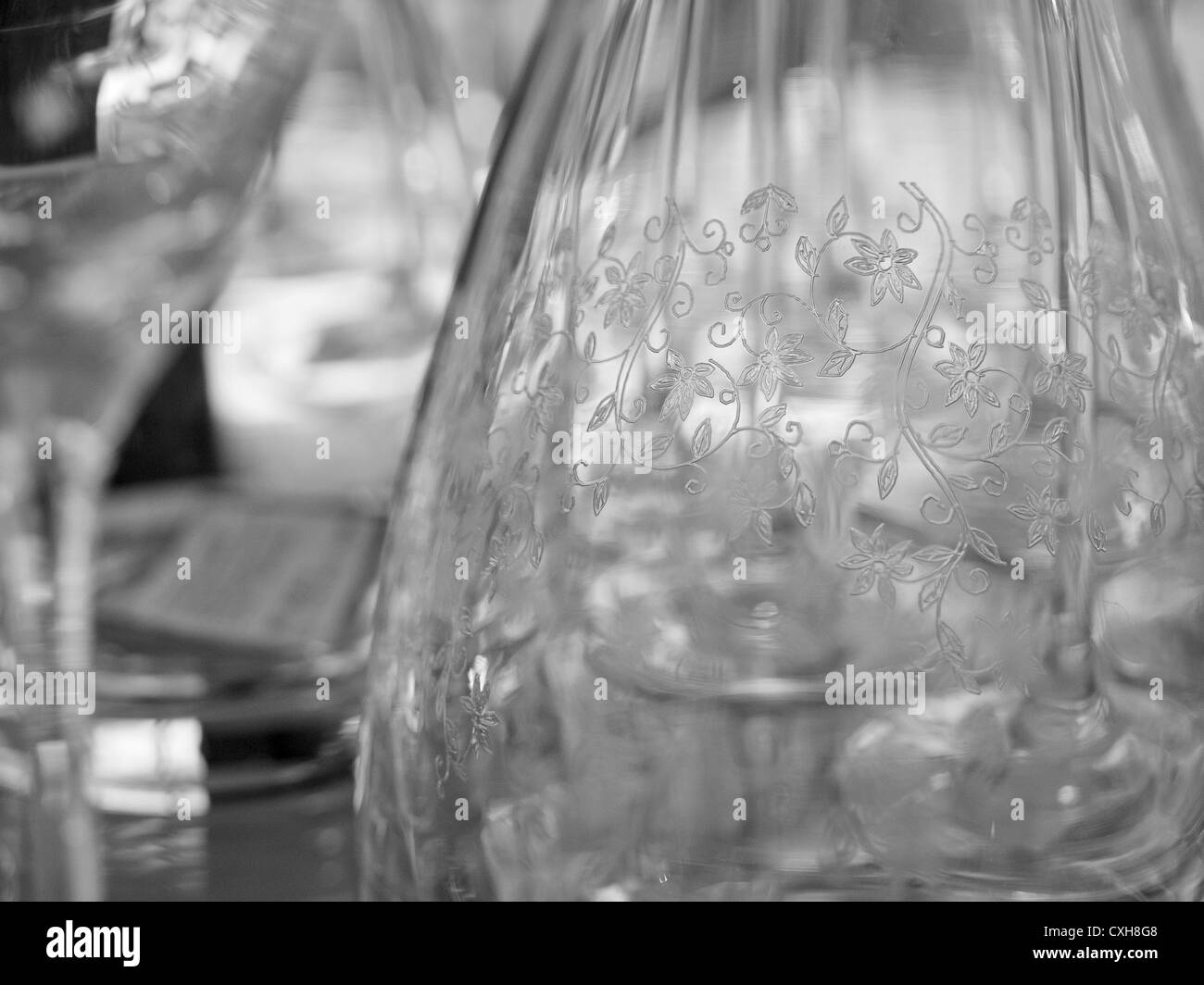 Monochrome detail of a transparent glass bottle, with a decorative pattern Stock Photo
