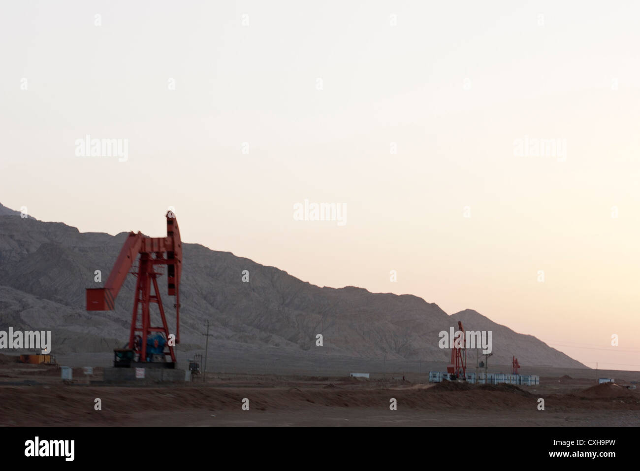 Nodding donkey pump jacks, or pumping units, are seen in the desert