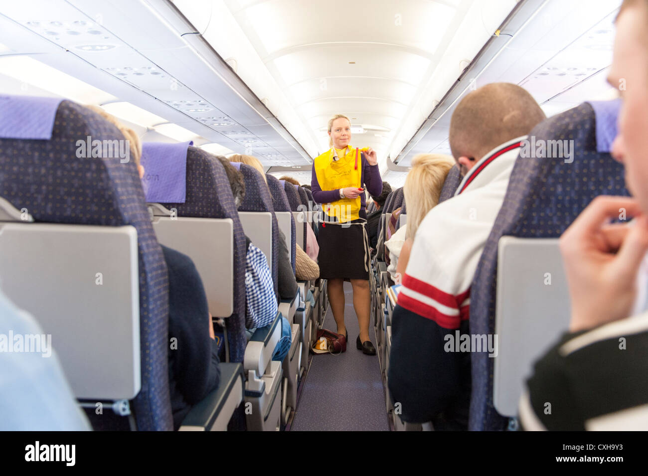 Monarch Airlines cabin crew going through preflight safety demonstration, England, UK Stock Photo