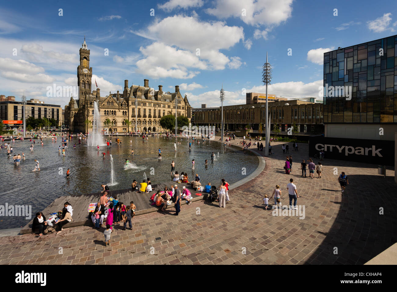 People enjoying the City Park water feature in Centenary Square